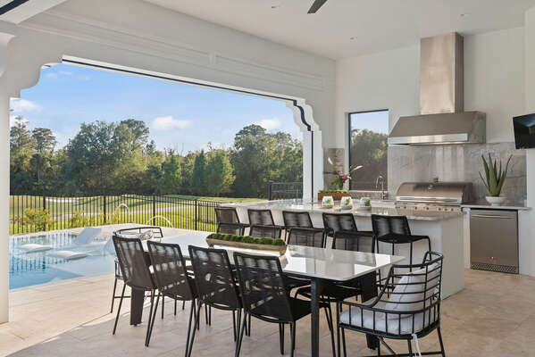 Enjoy the gorgeous outdoor living space, complete with a summer kitchen, wet bar and plenty of comfortable outdoor seating