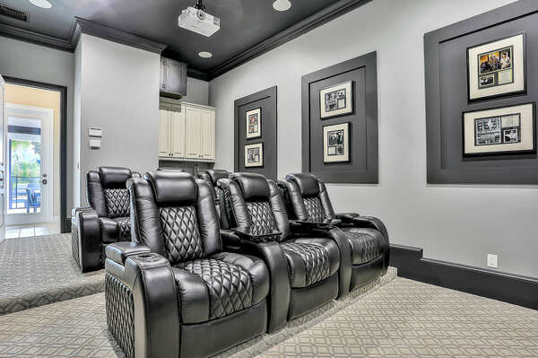 Watch a movie in comfort! These motorized luxury cinema recliners feature cupholders and tables for your enjoyment.