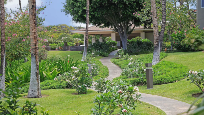 Lush landscaping around the pavilion and walkway to the pool
