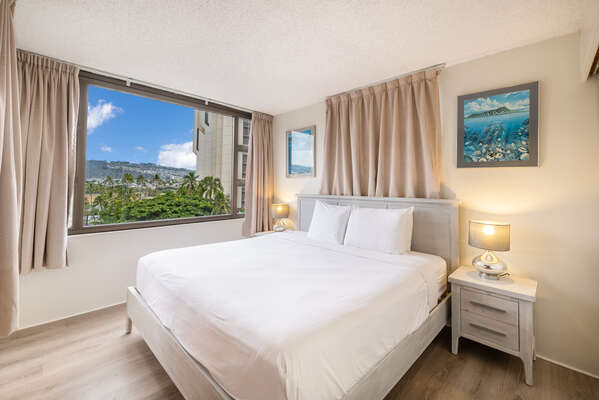 Bedroom with king-size bed, nightstands, and beautiful mountain view!
