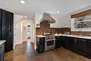 Gourmet Kitchen with stone countertops, ample counter-space, stainless steel Viking appliances, and Sub-zero fridge