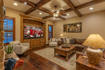 Great room features cozy seating to view the 82 in. TV.