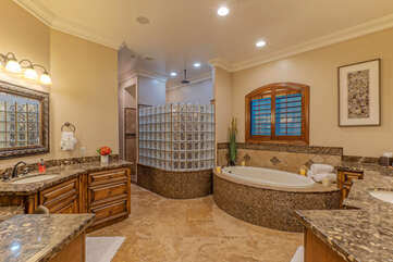 Luxurious primary bath with separate shower, Jacuzzi tub, walk-in closet and dual vanity sinks.