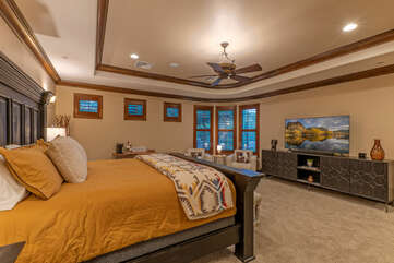 Primary suite has a trey ceiling with a ceiling fan, TV, coffee bar and sitting area.