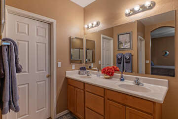 Ensuite primary bath features a vanity with dual sinks.
