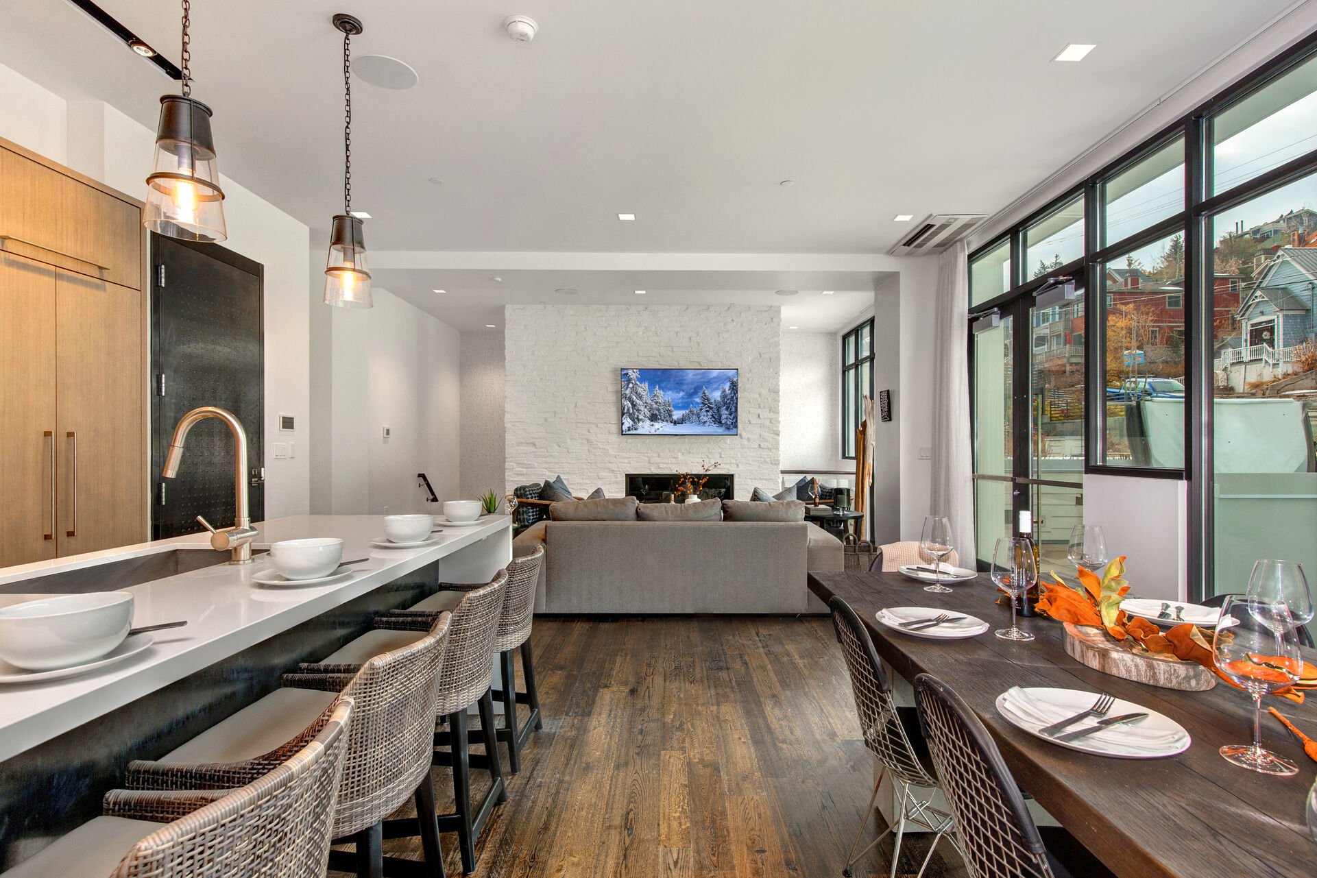 Main Level Great Room with a Hardwood Floor and Wall of Windows