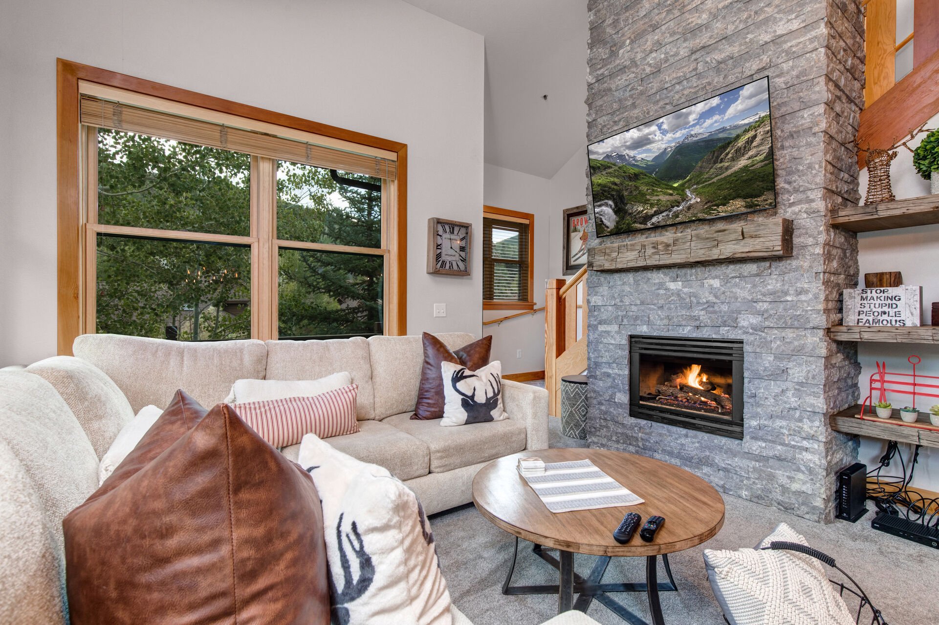 Cozy Living Room with plush sectional, gas fireplace, and 55