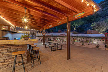 Life is good at the bar in exquisite outdoor setting with Traeger smoker and gas grill.