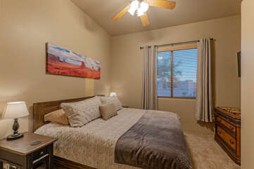 Bedroom 2 features a king bed and TV and uses the powder room or Bathroom 2.
