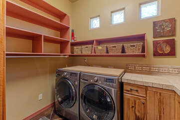 The dedicated laundry room is stocked with detergent and ready to help you manage your laundry chores.