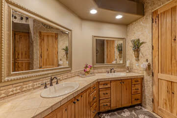 Primary ensuite bath has dual vanity sinks and enclosed water closet.