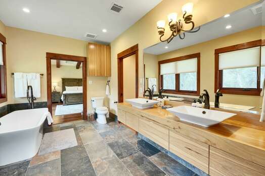 Master bath with 2 sinks, shower, and soaking tub
