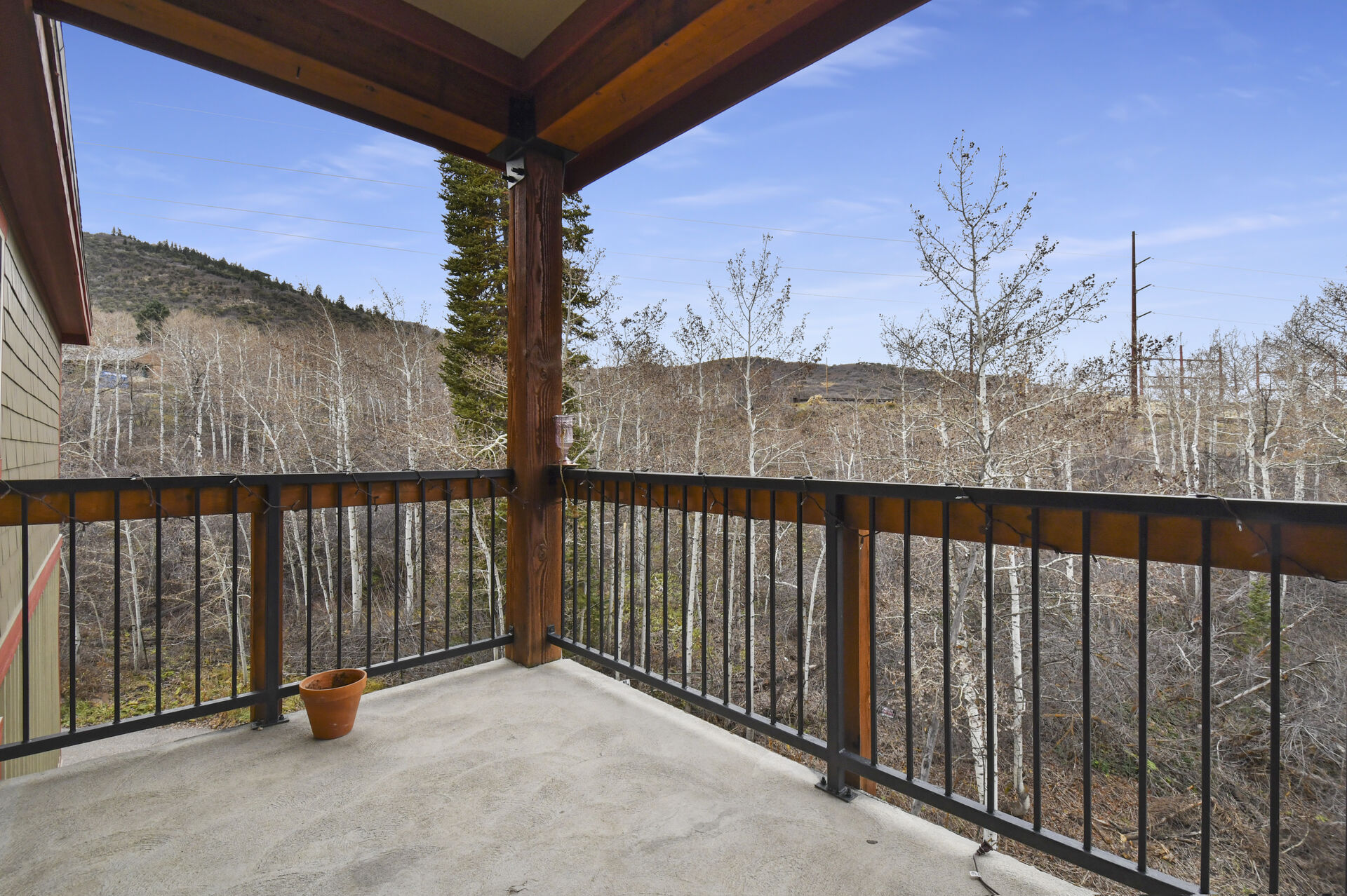 Balcony overlooking the forest with BBQ and chairs