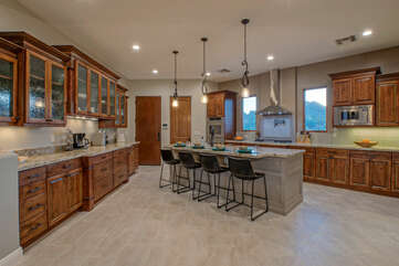 Spacious and modern kitchen is well stocked for prepping and serving delectable cuisine.