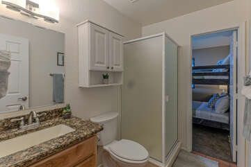 Bathroom 2 with a walk-in shower is shared between Bedroom 2 and visitors.