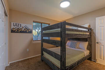 Bedroom 2 features two full size bunk beds with top safety rails.
