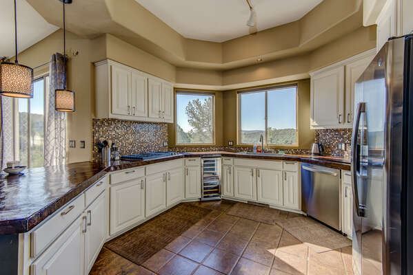 Chef's Kitchen with Stainless Steel Appliances Including a Wine Fridge