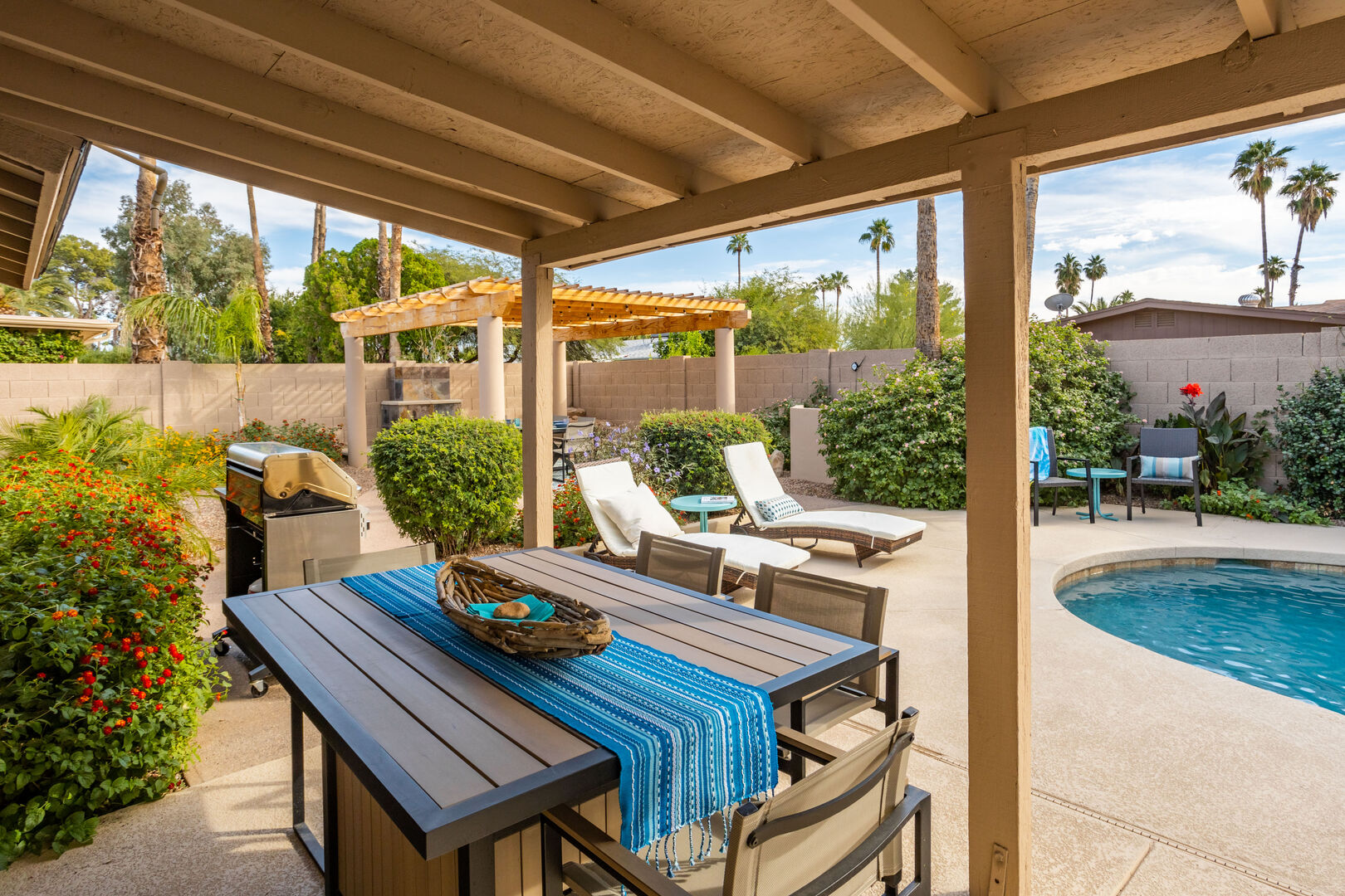 Sheltered Outdoor Dining w/ Grill & Pool in Background