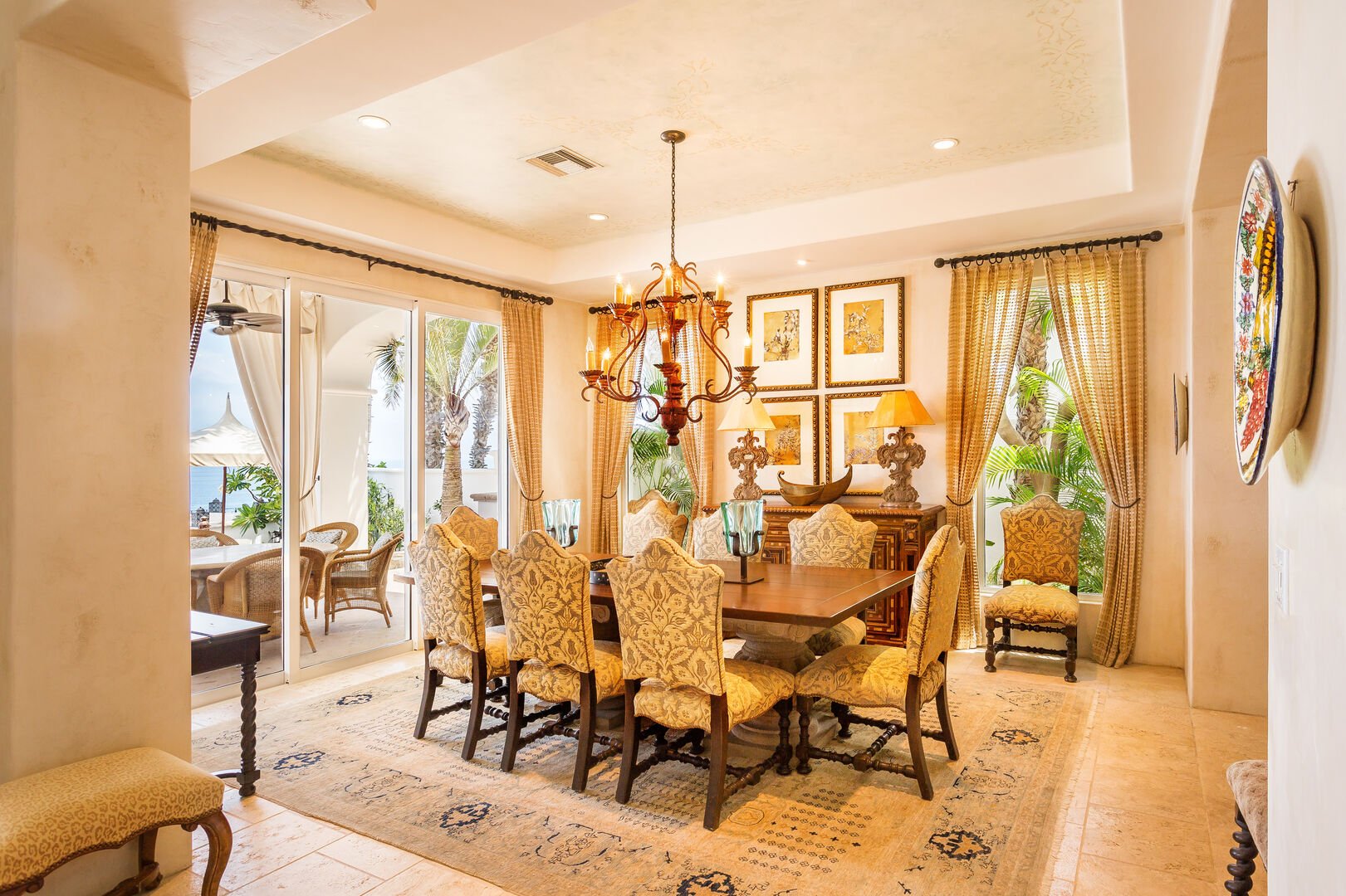 Dining table, chairs, and sliding glass doors to the outdoor patio with an ocean view