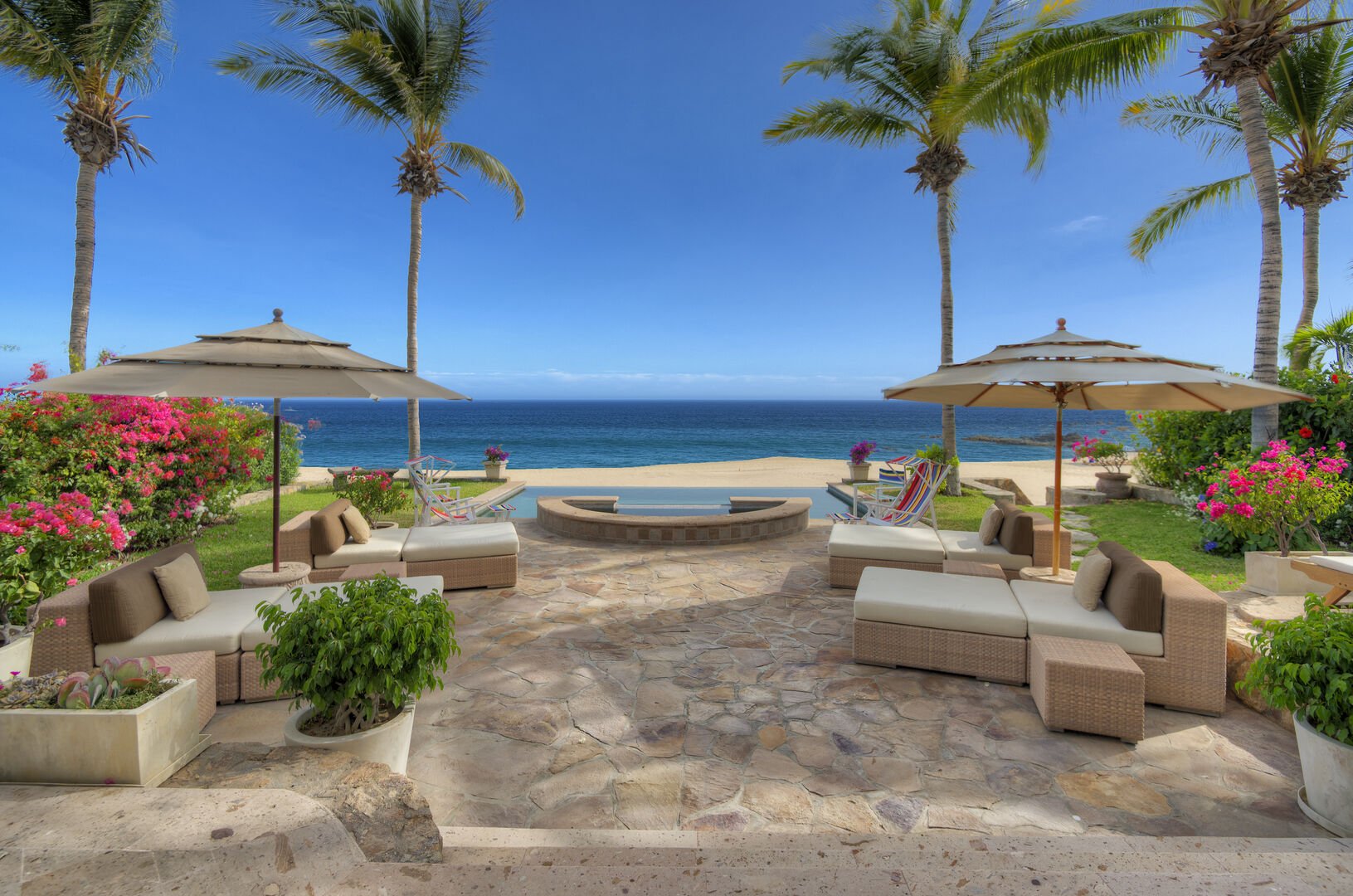 Chaise lounges by the infinity pool in our beachfront villa in Los Cabos, Mexico