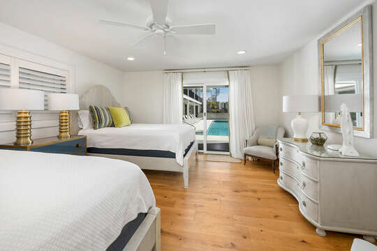 Guest Bedroom 2 with two queen-sized beds and direct access to the pool