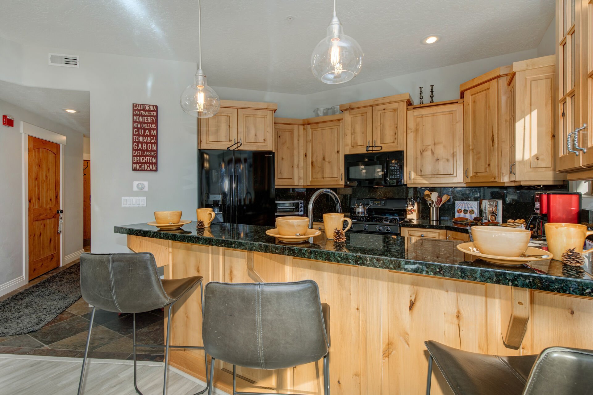 Fully Equipped Kitchen with stone countertops, ice-maker, and bar seating for 3