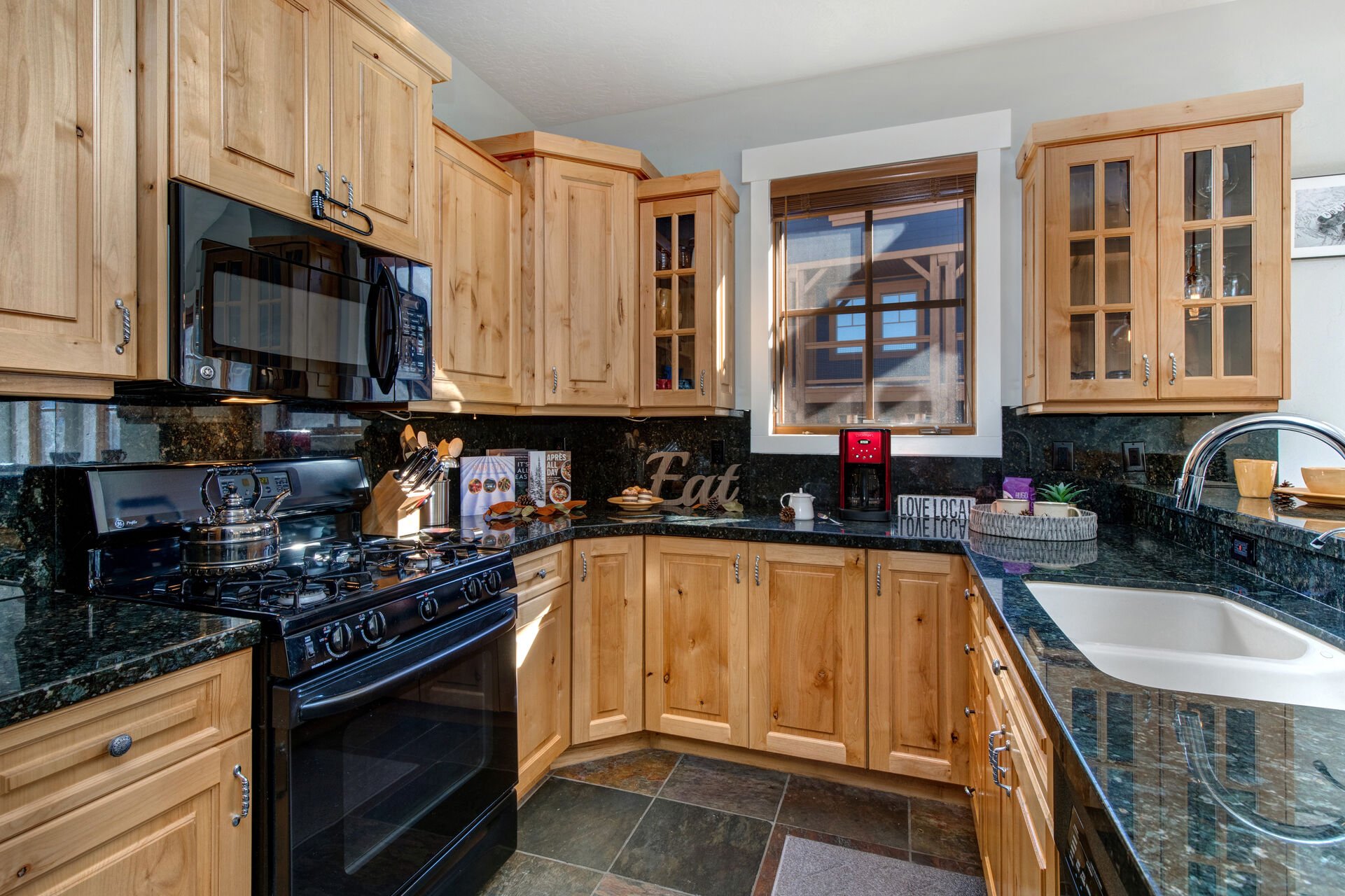 Fully Equipped Kitchen with stone countertops, ice-maker, and bar seating for 3