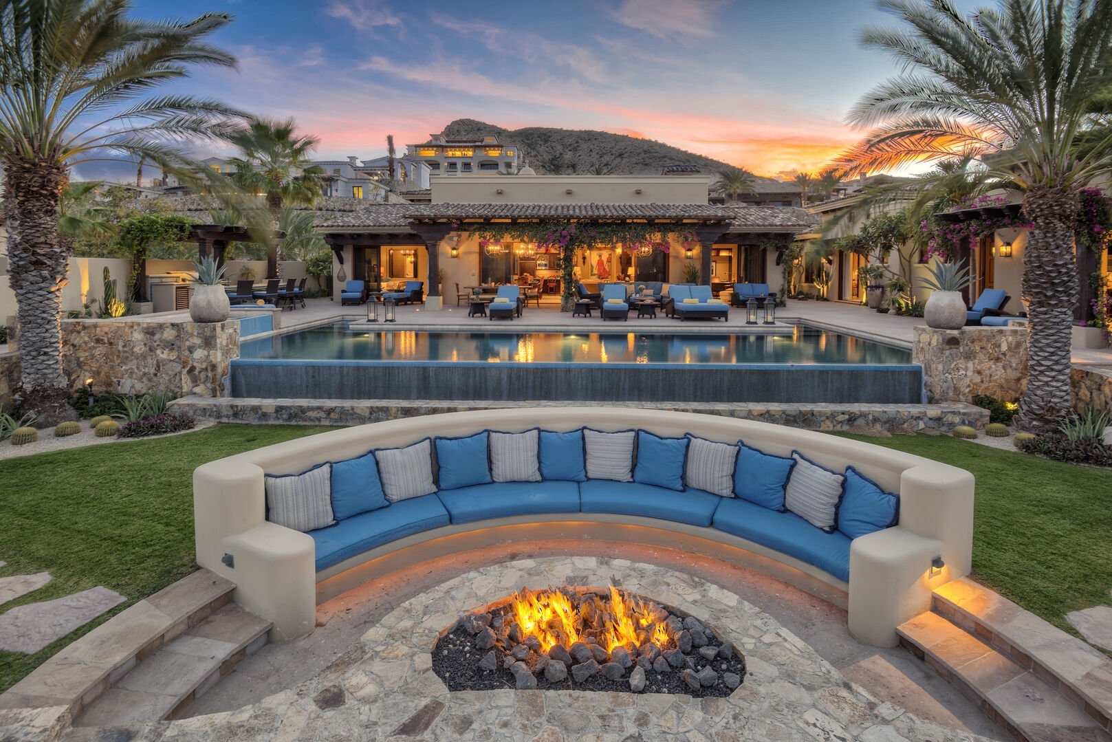 A lit fire pit and pool view at the Epiritu Casita 1
