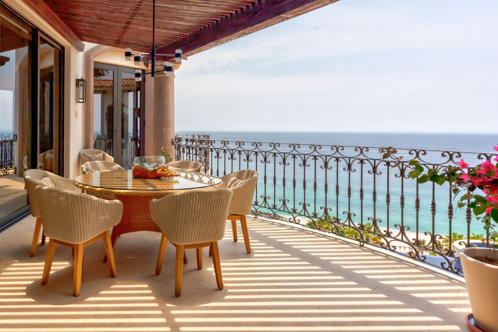An outdoor dining table with chairs and an ocean view at Hacienda 502