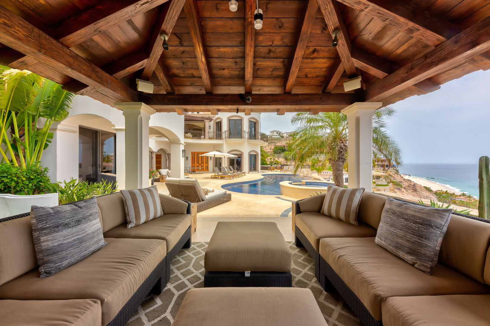 The outdoor fire place seating area with an ocean view at Hacienda 502