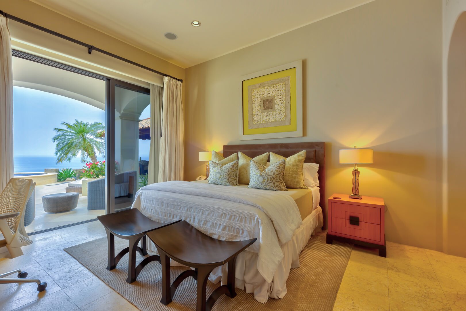 A bedroom with patio access and an ocean view at Hacienda 502