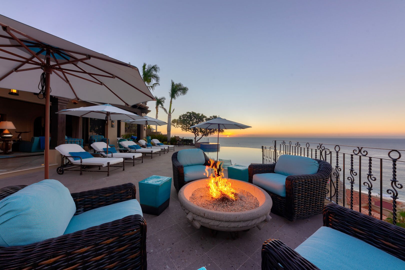A lit fire pit surrounded by chairs at the Espiritu Casita 101