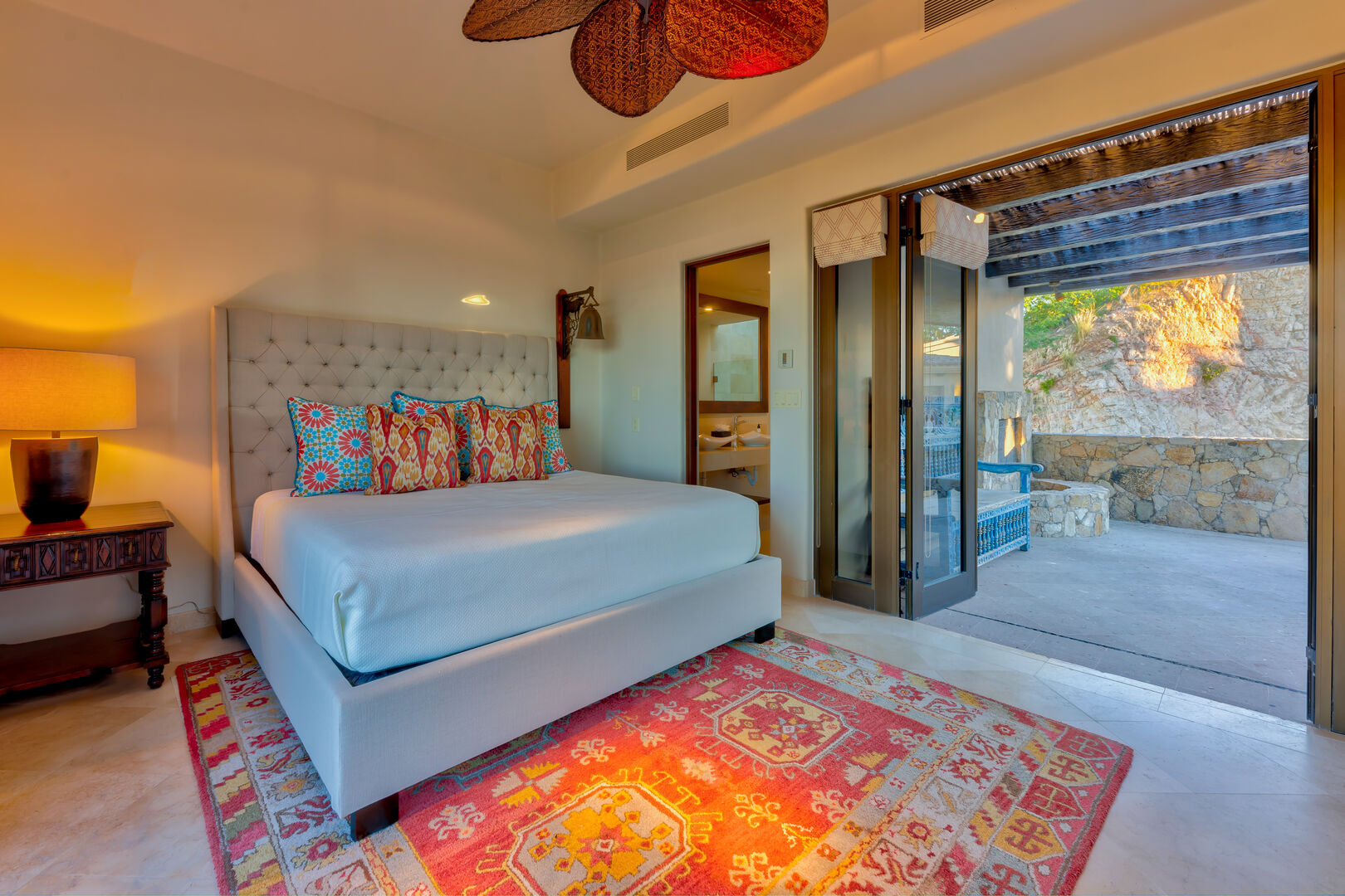 A bedroom with a covered patio seating area at the Espiritu Casita 101