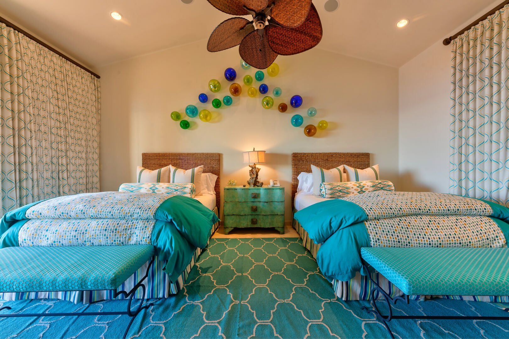 A bedroom with two beds and a ceiling fan at the Espiritu Casita 101