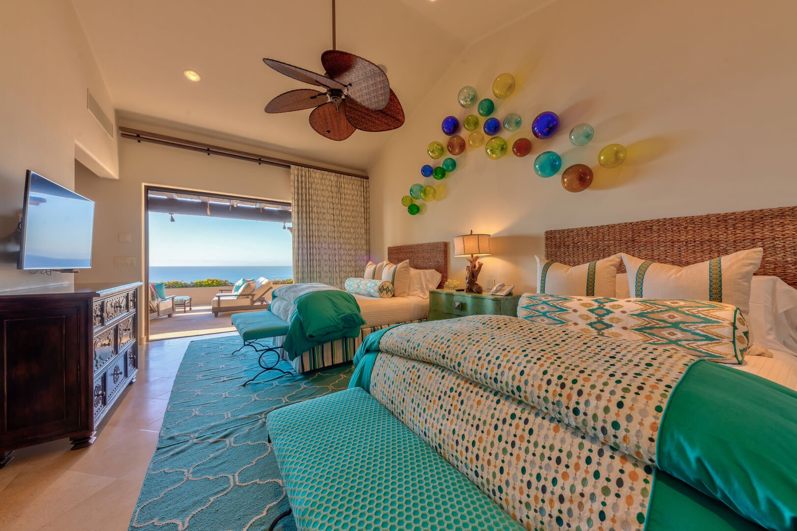 A bedroom with two beds and an ocean view at the Espiritu Casita 101