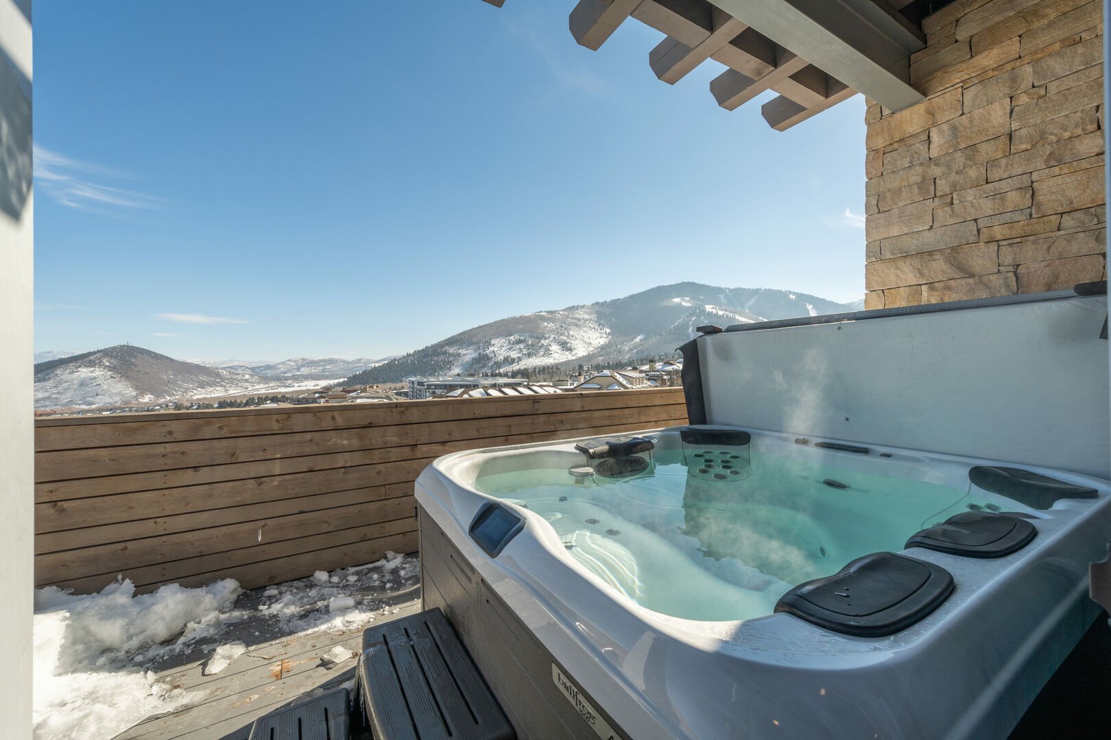 Private hot tub with a beautiful mountain view.