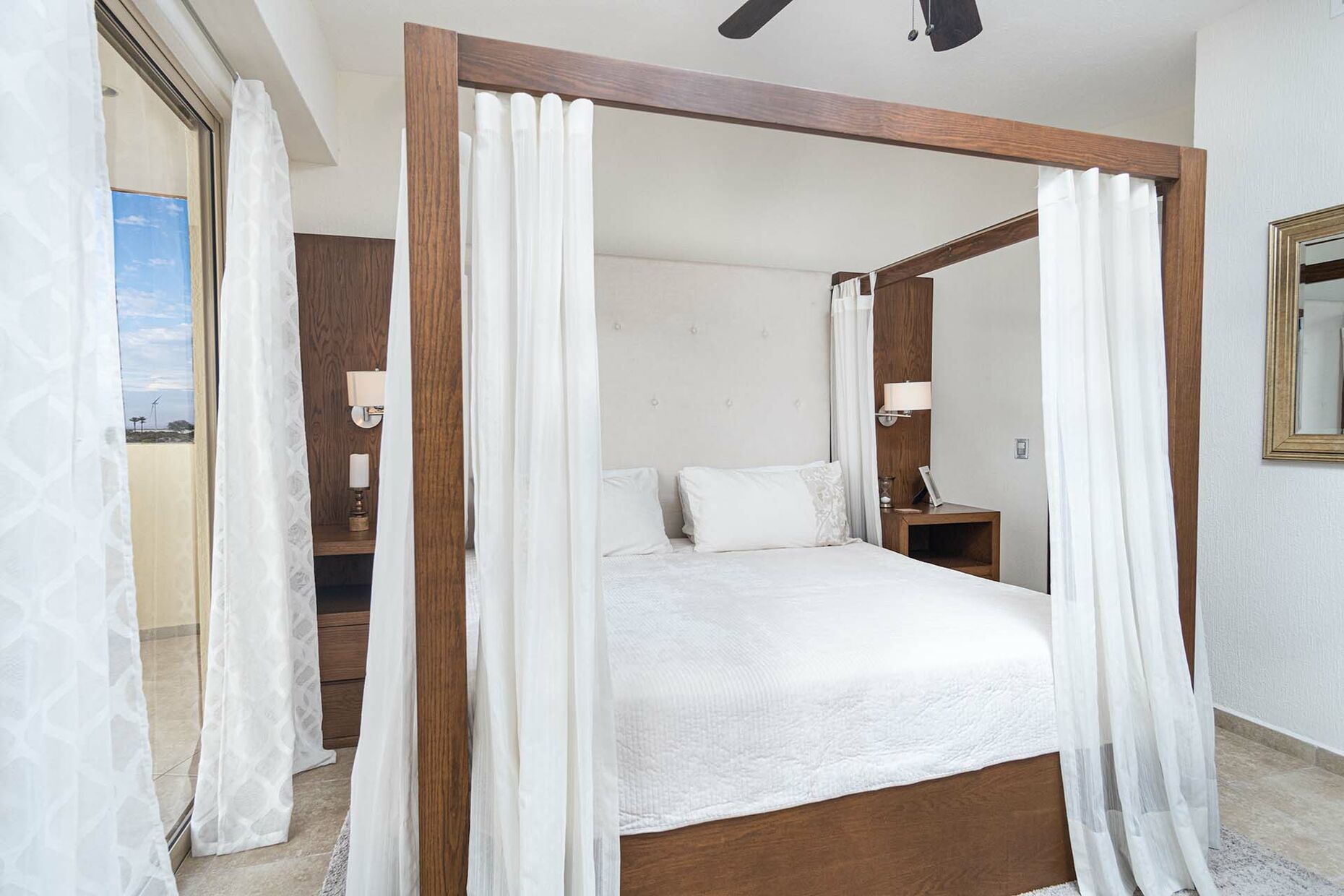 One of four bedrooms sports a romantic canopy  bed