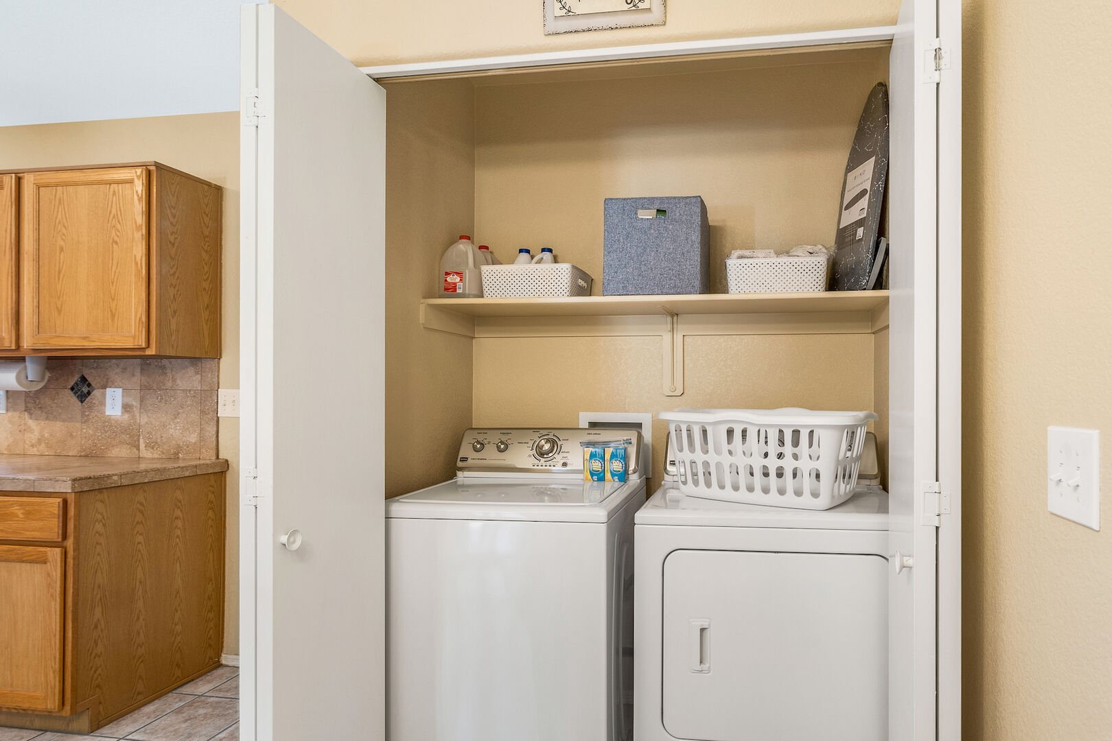 Full size washer and dryer in closet near kitchen convenient for guests on both sides of the house