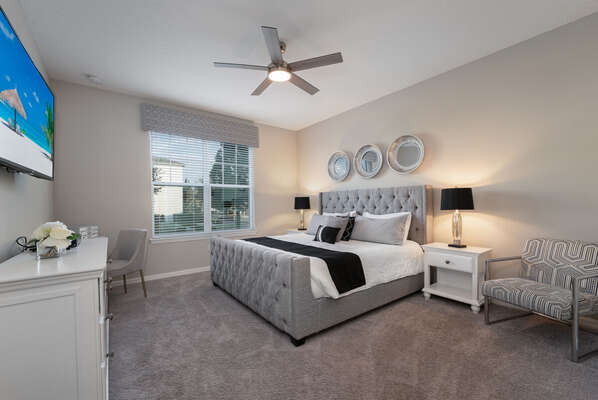 Downstairs has a spacious master suite with king bed, work space, accent chair