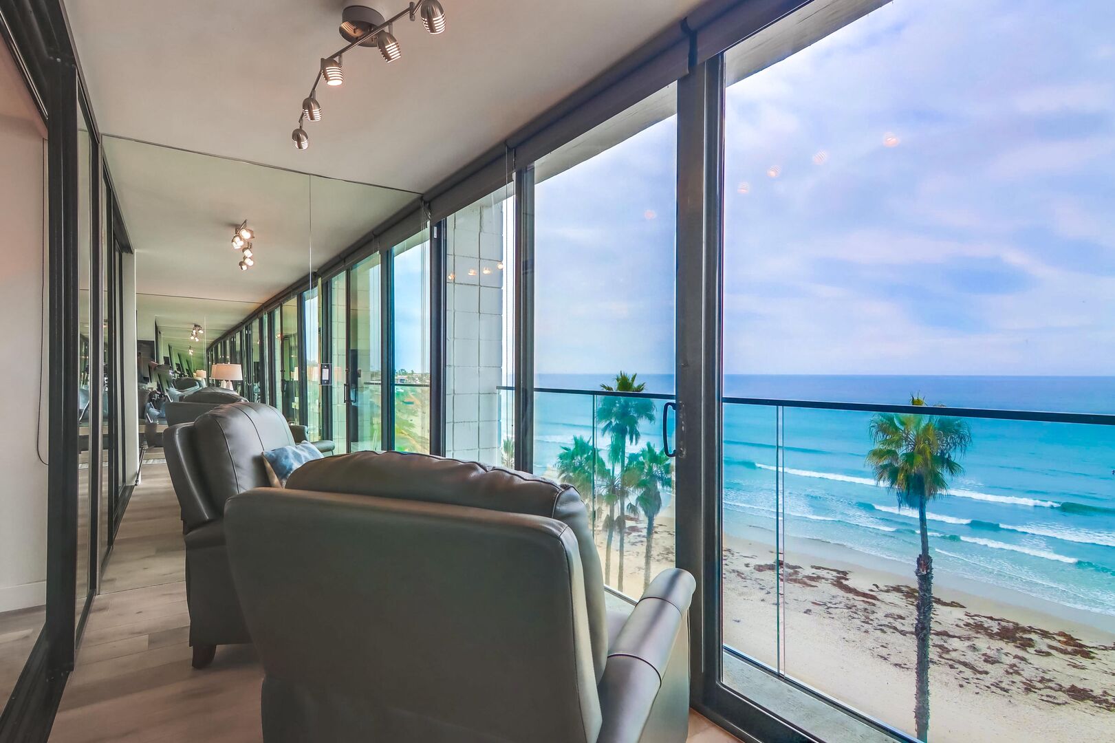 Sliding glass doors open to sea breeze and small standing space by railing. Blinds on all windows and doors are adjusted by a pulley chain.