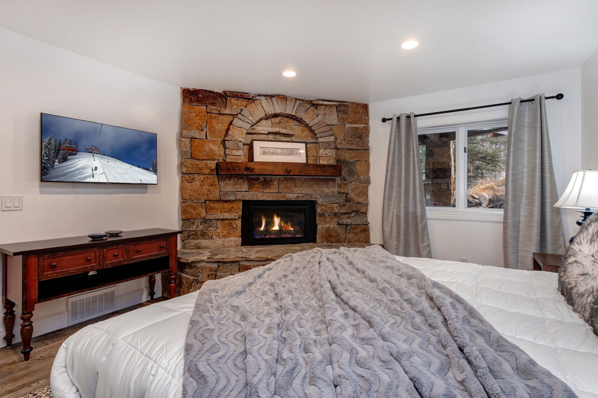 Lower Level Bedroom 2 with king bed, gas fireplace, Samsung smart TV, and en suite bathroom
