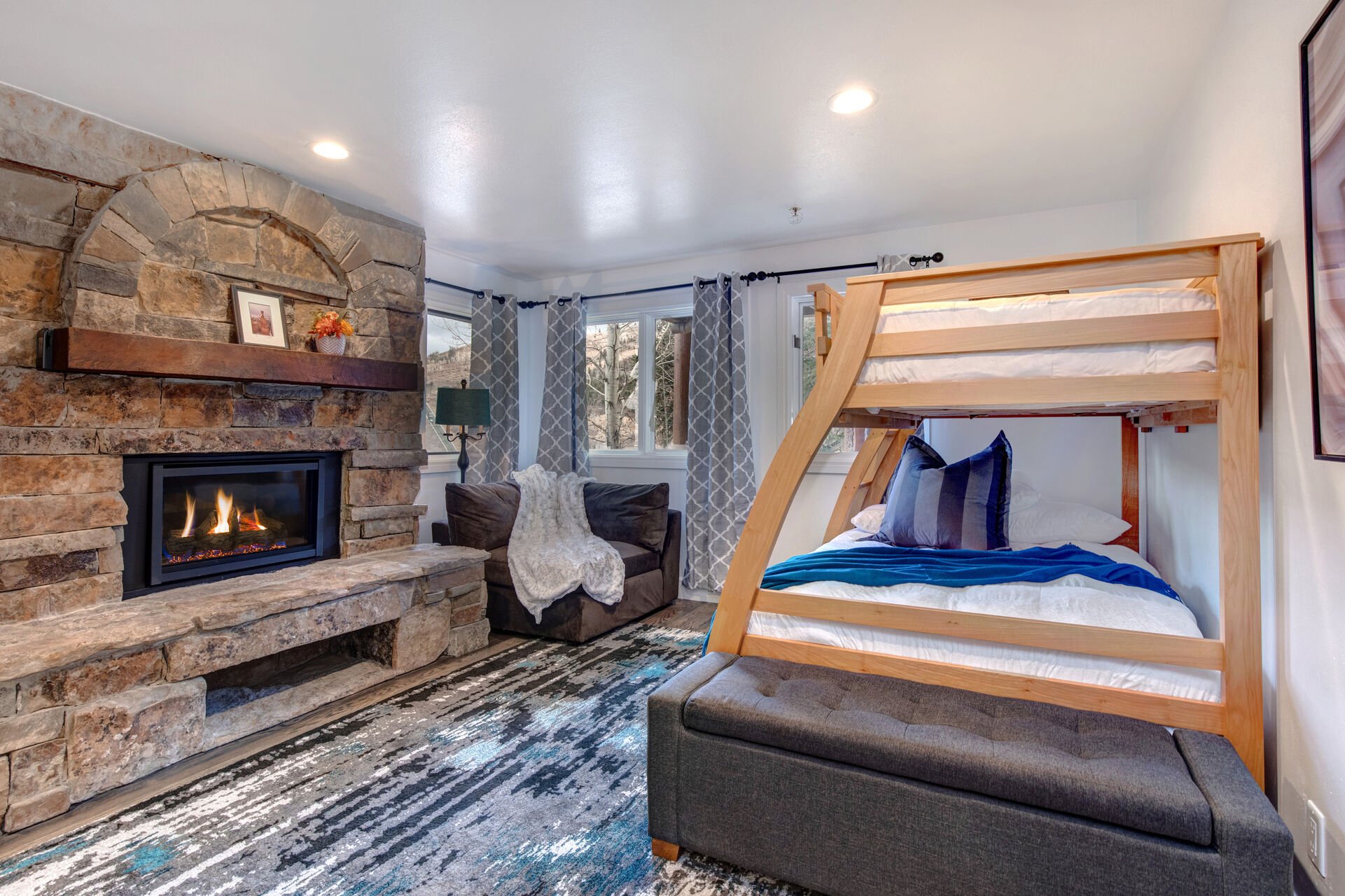 Lower Level Bedroom 3 with Twin over Full Bunkbed, seating area, gas fireplace, and en suite bathroom
