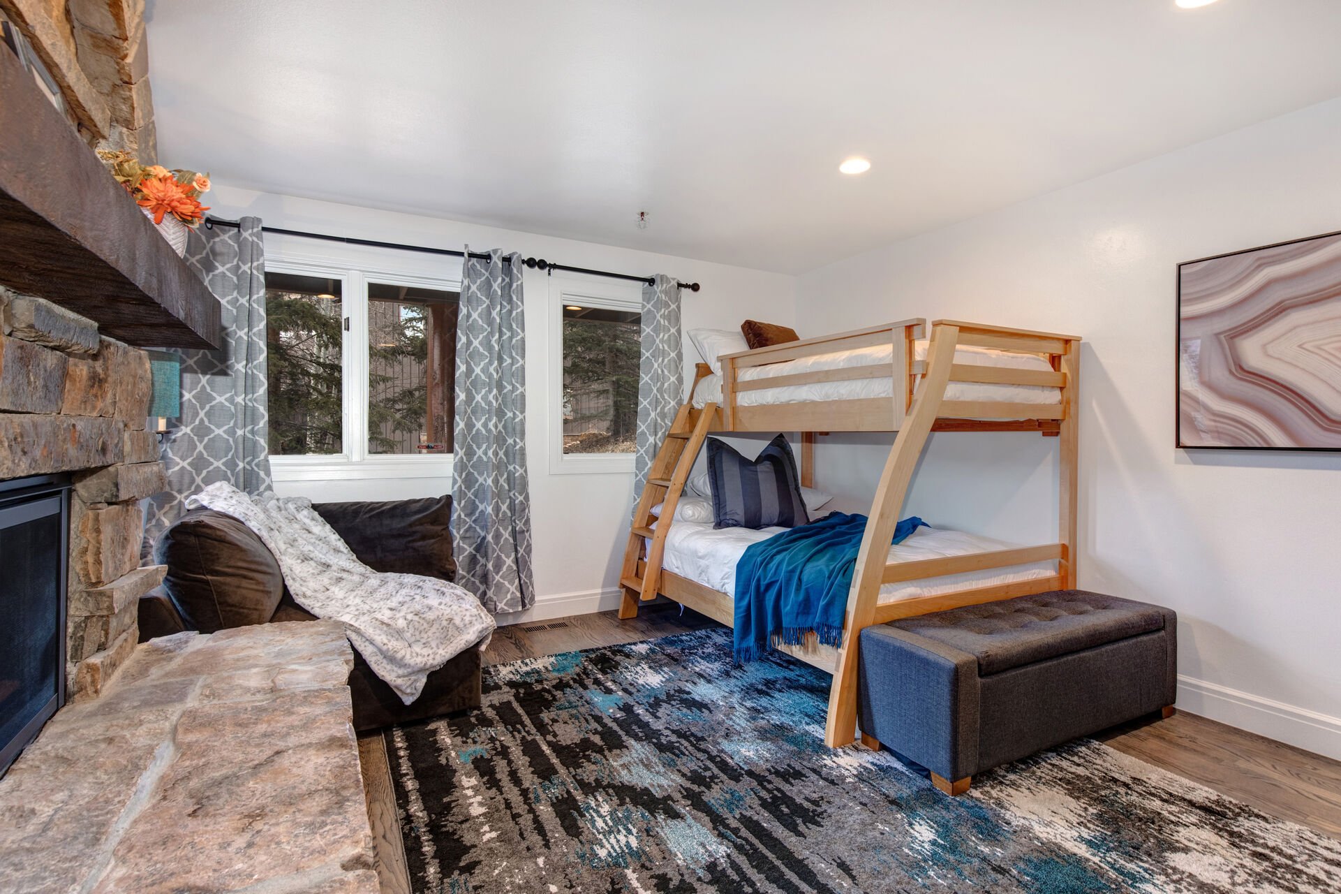 Lower Level Bedroom 3 with Twin over Full Bunkbed, seating area, gas fireplace, and en suite bathroom