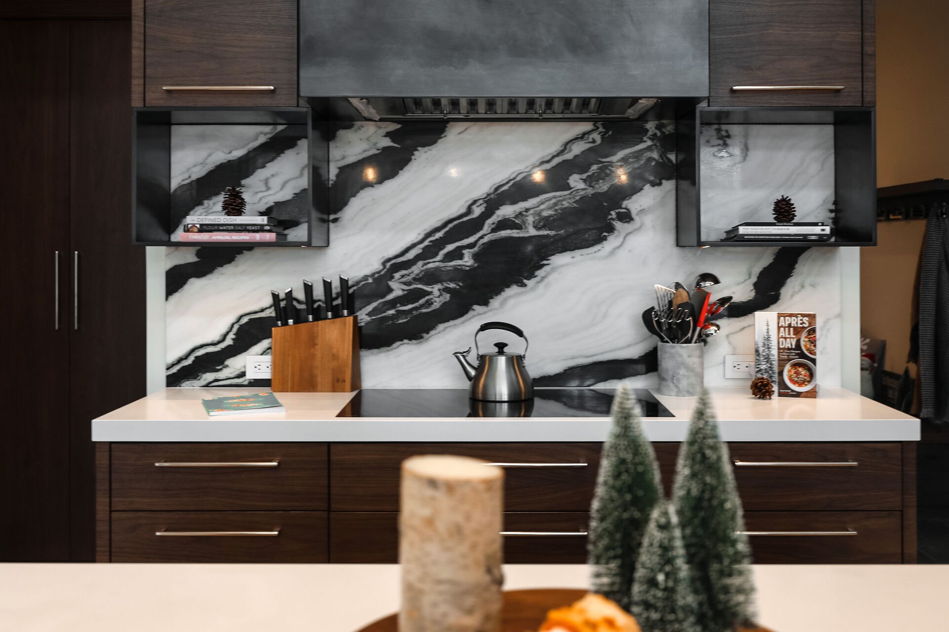 Open-layout, gourmet kitchen with gorgeous stone countertops,  double ovens, sub zero fridge, massive island with ample prep-space, and stunning marble backsplash