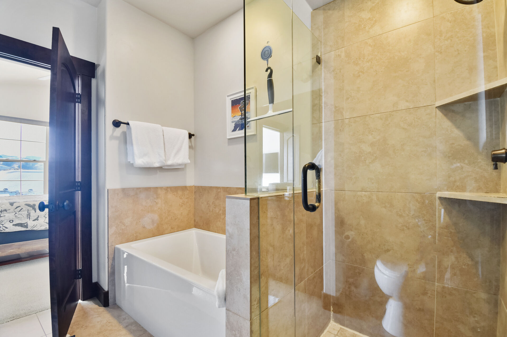 Master bathroom ensuite with bathtub and shower