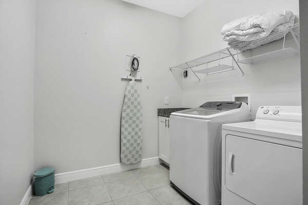 On the ground floor, there is a laundry room with full-sized washer and dryer, iron and ironing board