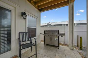 Covered outdoor patio on the lower level with propane grill
