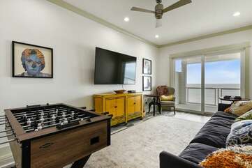 Second level den area with balcony access, TV and foosball table