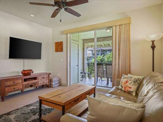 Living area with TV and ceiling fan at Hali'i Kai 20D