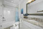 White bathroom with tub / shower combo